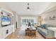 Cozy living room featuring wood floors, stylish furnishings, and sliding glass doors to a screened lanai at 5320 Crestlake Blvd # 26, Sarasota, FL 34233