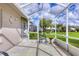 Screened in patio with seating area and view of the backyard at 5320 Crestlake Blvd # 26, Sarasota, FL 34233