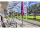 Relaxing screened lanai with patio furniture, offering peaceful outdoor living space with verdant view at 5320 Crestlake Blvd # 26, Sarasota, FL 34233