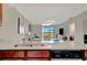 Modern kitchen with granite countertops overlooking the open-plan living area and outdoor views at 5710 Palmer Cir # 105, Bradenton, FL 34211