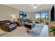 Comfortable living area with a plush sectional, accent chair, and sliding doors to the lanai at 5710 Palmer Cir # 105, Bradenton, FL 34211