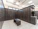 A well-lit locker room with sleek wooden lockers, tiled floor, and a comfortable bench at 5710 Palmer Cir # 105, Bradenton, FL 34211