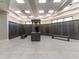 A spacious locker room featuring rows of wooden lockers, benches, and bright lighting at 5710 Palmer Cir # 105, Bradenton, FL 34211