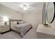 Serene main bedroom with neutral tones, a ceiling fan, bedside table, and accent mirror at 5710 Palmer Cir # 105, Bradenton, FL 34211