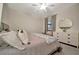 Serene main bedroom featuring neutral tones, a ceiling fan, and dresser with an accent mirror at 5710 Palmer Cir # 105, Bradenton, FL 34211