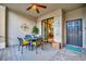 Cozy outdoor patio featuring a dining set and ceiling fan offers a relaxing retreat at 5710 Palmer Cir # 105, Bradenton, FL 34211