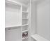 Walk-in closet with white shelving and ample storage space at 5907 Guarino Dr, Sarasota, FL 34238