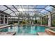 Lush screened pool and spa area with brick pavers and plenty of seating at 7028 Lacantera Cir, Lakewood Ranch, FL 34202