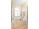 Bright bathroom featuring a large tub under a window with shutter blinds at 7113 91St E St, Palmetto, FL 34221