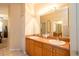 Bathroom featuring double sinks, a large mirror, and tile floors at 7113 91St E St, Palmetto, FL 34221