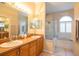 Bathroom featuring double sinks, a glass shower, and a bathtub at 7113 91St E St, Palmetto, FL 34221