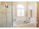 Bright bathroom featuring a large tub under a window with shutter blinds at 7113 91St E St, Palmetto, FL 34221