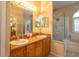 Bathroom featuring double sinks, a glass shower, and a bathtub at 7113 91St E St, Palmetto, FL 34221