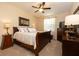 This bedroom features a wooden bed frame, ceiling fan, and carpet flooring at 7113 91St E St, Palmetto, FL 34221
