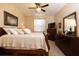 This bedroom features a wooden bed frame, ceiling fan, carpet floors and a dresser at 7113 91St E St, Palmetto, FL 34221