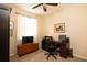 Bedroom with a ceiling fan and a wooden chest near a bright window at 7113 91St E St, Palmetto, FL 34221