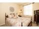 Comfortable bedroom with a wooden bed frame, decorative pillows, and a geometric wall decor piece at 7113 91St E St, Palmetto, FL 34221