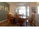 Charming dining room featuring a wood table, chandelier and natural light from large arched windows at 7113 91St E St, Palmetto, FL 34221