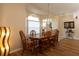 A dining room featuring a wood table with chairs illuminated by a modern chandelier at 7113 91St E St, Palmetto, FL 34221