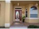 Close-up of the front door with decorative glass, sidelight window, and a welcoming porch at 7113 91St E St, Palmetto, FL 34221