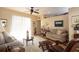 Bright living room with natural light, neutral sofas, a ceiling fan and comfortable seating at 7113 91St E St, Palmetto, FL 34221
