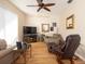 Cozy living room features a ceiling fan, wood flooring, and comfortable furnishings at 7113 91St E St, Palmetto, FL 34221