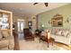 Inviting living room featuring comfortable seating, a decorative mirror, and warm neutral tones at 7113 91St E St, Palmetto, FL 34221