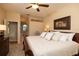 This spacious main bedroom features carpet floors, a ceiling fan, and a doorway to the ensuite bath at 7113 91St E St, Palmetto, FL 34221