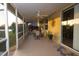 Enclosed patio with ceiling fans, outdoor seating, and an accent wall decoration at 7113 91St E St, Palmetto, FL 34221