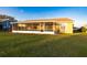 The screened porch is a serene transition to the backyard, complemented by a well-kept lawn and landscaping at 7113 91St E St, Palmetto, FL 34221