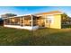 Enjoy outdoor living with this screened porch, offering a seamless blend of indoor comfort and outdoor charm in the backyard at 7113 91St E St, Palmetto, FL 34221