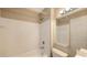 Clean white tiled bathroom with shower and tub combination at 850 S Tamiami Trl # 301, Sarasota, FL 34236