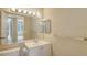 Clean bathroom vanity with large mirror and recessed lighting at 850 S Tamiami Trl # 301, Sarasota, FL 34236