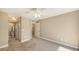Bedroom featuring carpet, ceiling fan, and an ensuite bathroom with neutral tones at 850 S Tamiami Trl # 301, Sarasota, FL 34236