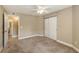 Carpeted bedroom with an ensuite bathroom and large closet at 850 S Tamiami Trl # 301, Sarasota, FL 34236