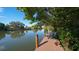 Community dock with benches overlooking calm water surrounded by green vegetation and residential buildings at 850 S Tamiami Trl # 301, Sarasota, FL 34236