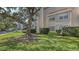 Well-maintained building exterior surrounded by mature trees and landscaping at 850 S Tamiami Trl # 301, Sarasota, FL 34236