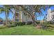 Beautiful condo building exterior with lush green grass and mature tree for plenty of shade at 850 S Tamiami Trl # 301, Sarasota, FL 34236
