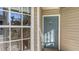 Close-up of a unit's front door with house number and a window showing the reflection of trees at 850 S Tamiami Trl # 301, Sarasota, FL 34236