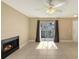 Cozy living room with tile floor, sliding door, fireplace, and neutral color scheme at 850 S Tamiami Trl # 301, Sarasota, FL 34236