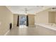 Open living space with tile flooring, ceiling fan, fireplace, and sliding door leading to the outdoors at 850 S Tamiami Trl # 301, Sarasota, FL 34236