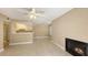 Open living space with tile floors, fireplace, and adjacent kitchen featuring white cabinetry at 850 S Tamiami Trl # 301, Sarasota, FL 34236