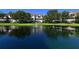 Scenic view of a community pond featuring a fountain and surrounding lush green landscaping at 850 S Tamiami Trl # 301, Sarasota, FL 34236