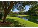 Scenic view of a community pond with a fountain and surrounding lush green landscaping at 850 S Tamiami Trl # 301, Sarasota, FL 34236
