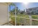 View from the screened porch with lush landscaping, building exterior, and blue sky above at 850 S Tamiami Trl # 301, Sarasota, FL 34236