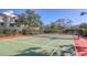 Well-maintained community tennis court surrounded by lush landscaping and residential buildings at 850 S Tamiami Trl # 301, Sarasota, FL 34236