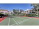 Well-maintained community tennis court with benches surrounded by lush landscaping and residential buildings at 850 S Tamiami Trl # 301, Sarasota, FL 34236