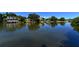 Scenic community waterfront view showcasing residential houses lining the opposite shoreline at 850 S Tamiami Trl # 301, Sarasota, FL 34236