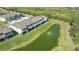 Aerial shot of the property showcasing the building's exterior and serene pond at 8612 Milestone Dr, Sarasota, FL 34238