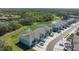 Aerial view of the townhomes backing onto lush green space, offering privacy and scenic views at 8612 Milestone Dr, Sarasota, FL 34238